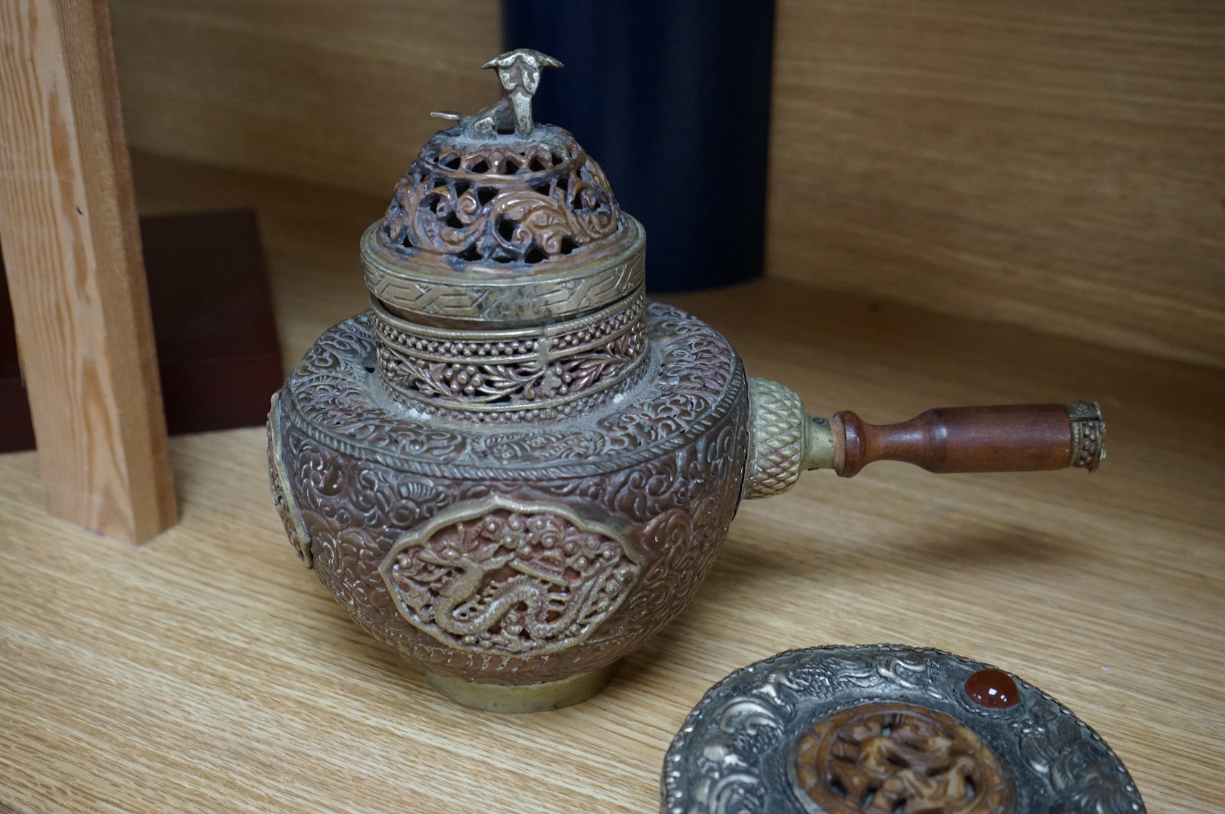 A Tibetan copper and brass pot and a similar box and cover with mirrored interior, largest 19cm high (2). Condition - poor to fair